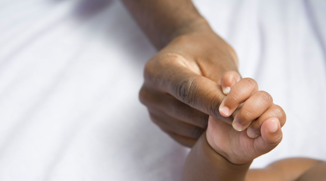 Adult and child holding hands