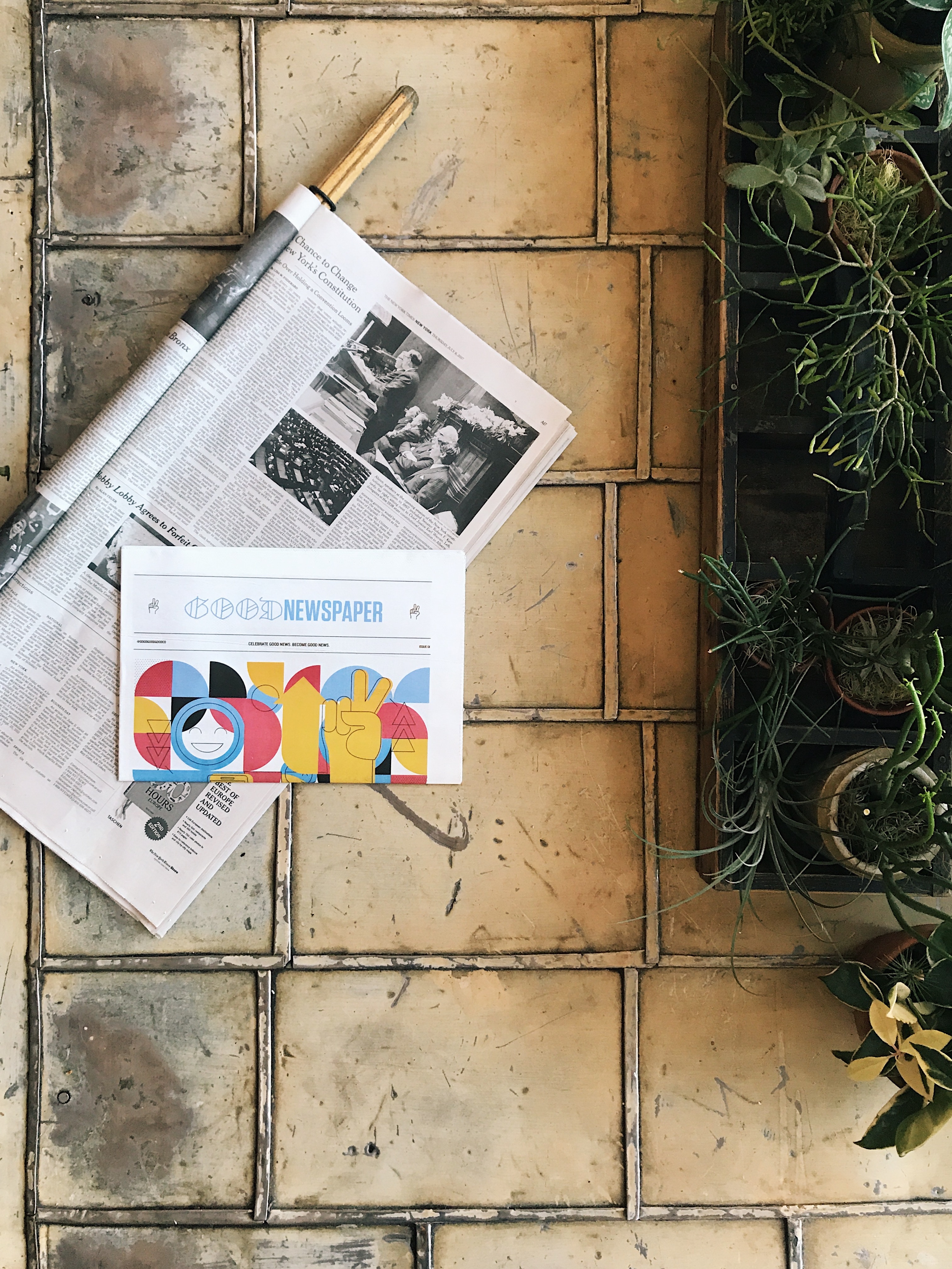 Newspapers in stack on floor