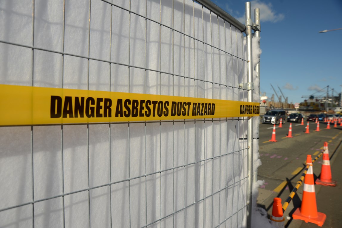Sign saying "danger asbestos dust nearby"