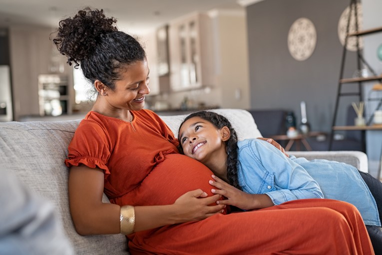 Pregnant woman and child snuggling