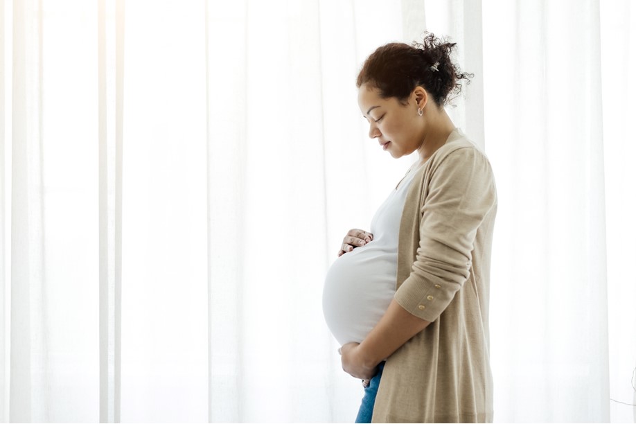 Pregnant woman with hands on belly