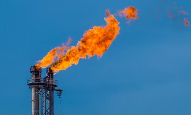 Oil refinery flames from smokestacks