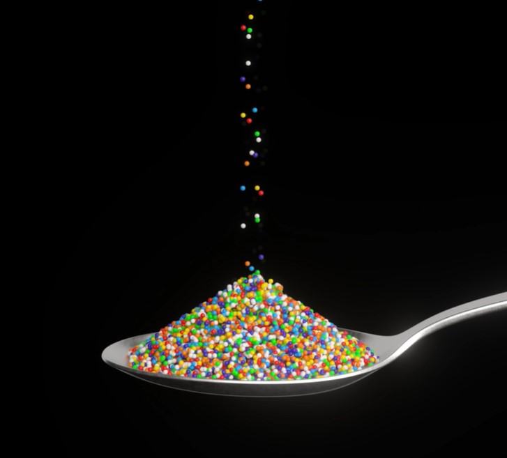 Spoon with microplastics being poured into it