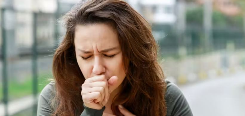 Woman coughing while exercising