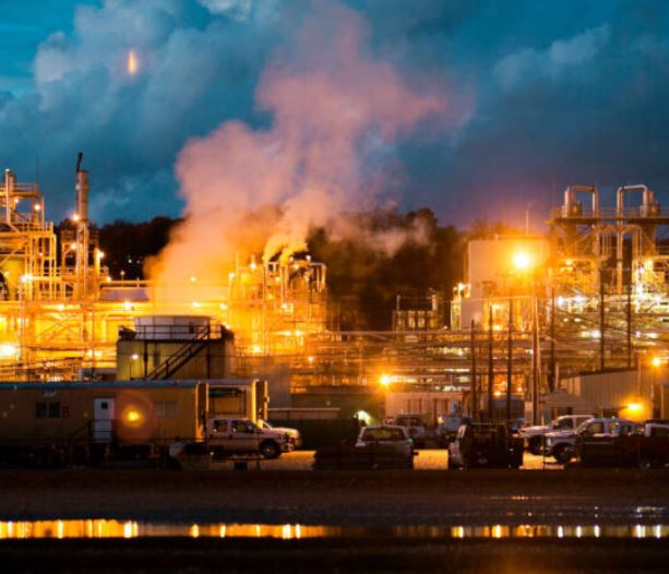 Chemical plant against dark sky