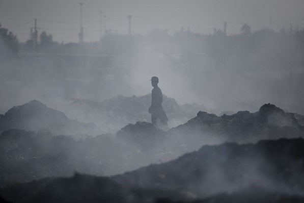 Worker stands in smoky environment