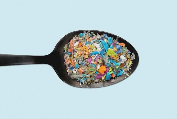 Spoon with microplastic particles in it
