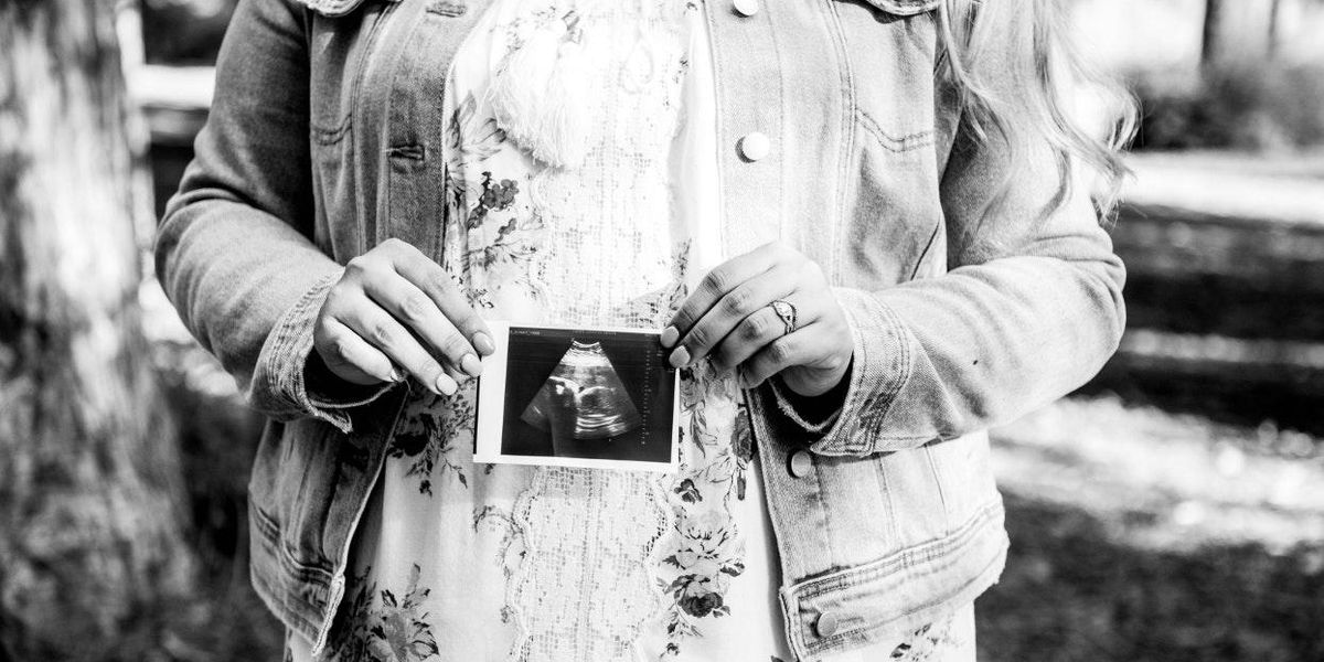 Women holding an image of a ultrasound