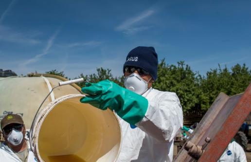 Farm workers preparing pesticides