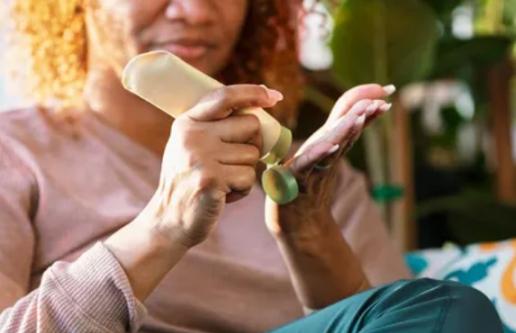 Woman applying hand cream