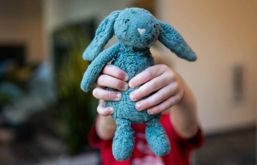 Hands holding microfleece teddy bear