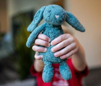 Hands holding microfleece teddy bear
