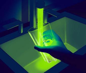 Glowing water flowing into water glass