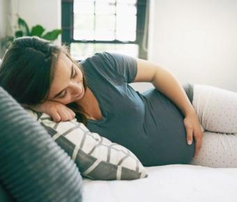 Pregnant women sleeping on a bed