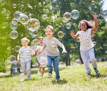 Kids chasing bubbles