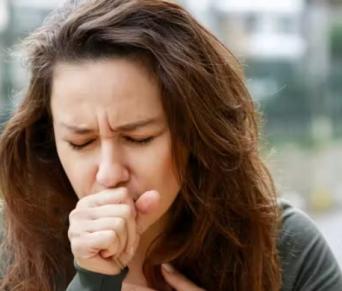 Woman coughing while exercising